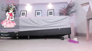 Solo performer with a toy on rumpled bedsheets