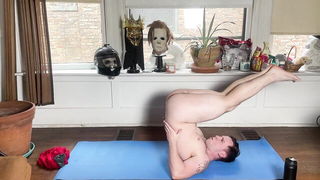 Solo performer with a toy on rumpled bedsheets