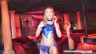 Solo performer with a toy on rumpled bedsheets