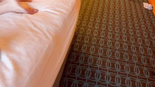 Couple on a made bed in an explicit scene