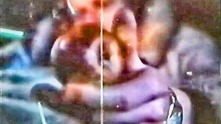 Explicit massage scene in a softly lit room