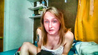 Solo performer with a toy on rumpled bedsheets