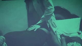 Studio set with performers in an explicit scene under bright lights