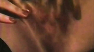 Couple on a made bed in an explicit scene