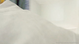 Couple on a patterned bedspread in an explicit scene