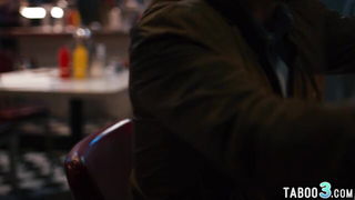 Couple on a made bed in an explicit scene