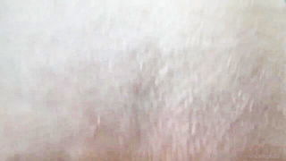 Couple on a patterned bedspread in an explicit scene