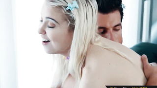 Couple on a made bed in an explicit scene