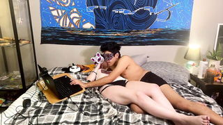 Couple on a made bed in an explicit scene