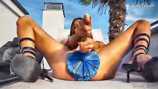 Solo performer with a toy on rumpled bedsheets