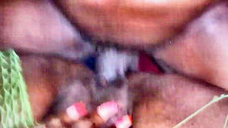 Couple on a made bed in an explicit scene