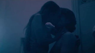 Couple on a made bed in an explicit scene