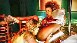 Studio set with performers in an explicit scene under bright lights