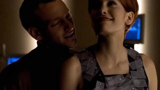 Couple on a patterned bedspread in an explicit scene