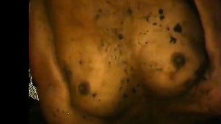 Explicit massage scene in a softly lit room