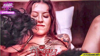 Couple on a made bed in an explicit scene