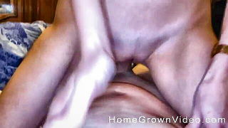 Solo performer with a toy on rumpled bedsheets