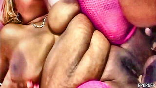 Solo performer with a toy on rumpled bedsheets