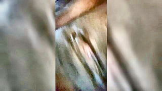 Amateur couple on a living room sofa in explicit scene