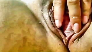 Couple on a patterned bedspread in an explicit scene