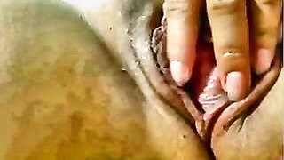 Couple on a patterned bedspread in an explicit scene