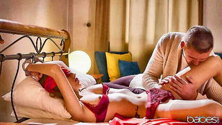 Amateur couple on a living room sofa in explicit scene