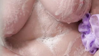 Explicit massage scene in a softly lit room