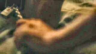 Couple mid-scene in a dim bedroom