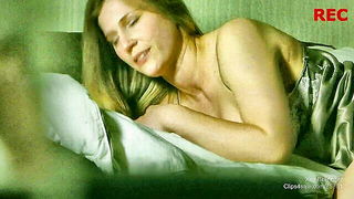 Amateur couple on a living room sofa in explicit scene
