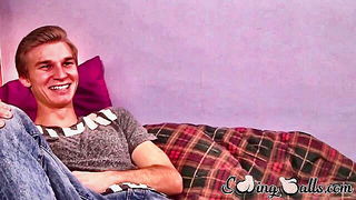 Solo performer with a toy on rumpled bedsheets