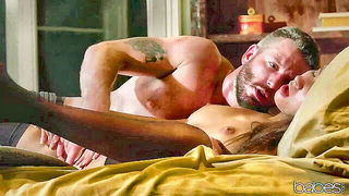 Amateur couple on a living room sofa in explicit scene