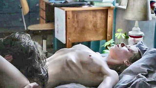 Couple mid-scene in a dim bedroom
