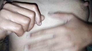 Couple on a made bed in an explicit scene