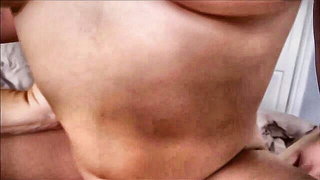 Explicit massage scene in a softly lit room