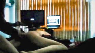 Couple on a made bed in an explicit scene