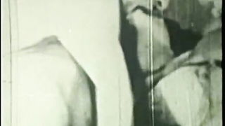 Couple mid-scene in a dim bedroom
