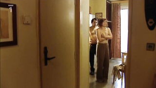 Amateur couple on a living room sofa in explicit scene