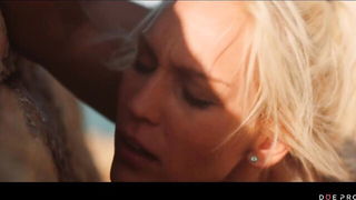 Couple mid-scene in a dim bedroom