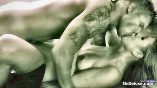 Couple mid-scene in a dim bedroom