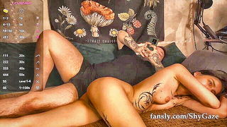 Amateur couple on a living room sofa in explicit scene