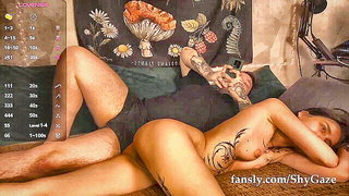 Amateur couple on a living room sofa in explicit scene
