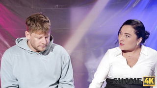 Studio set with performers in an explicit scene under bright lights