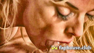 Couple on a patterned bedspread in an explicit scene