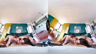 Amateur couple on a living room sofa in explicit scene