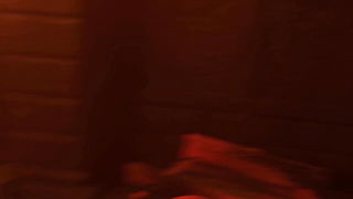 Solo performer with a toy on rumpled bedsheets
