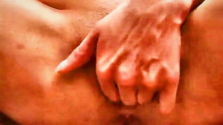 Explicit massage scene in a softly lit room