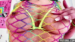 Couple on a patterned bedspread in an explicit scene