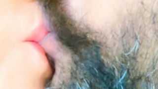 Couple on a made bed in an explicit scene
