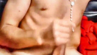 Amateur couple on a living room sofa in explicit scene