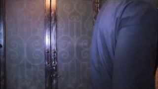 Couple mid-scene in a dim bedroom